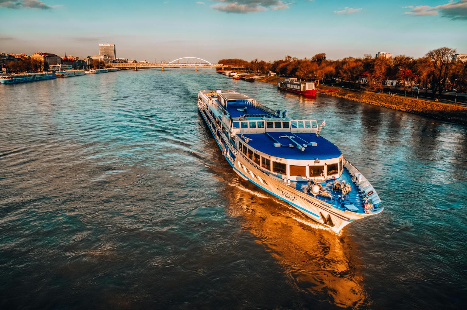 Capture of a cruise ship sailing on the Danube River during sunset in Bratislava, Slovakia.