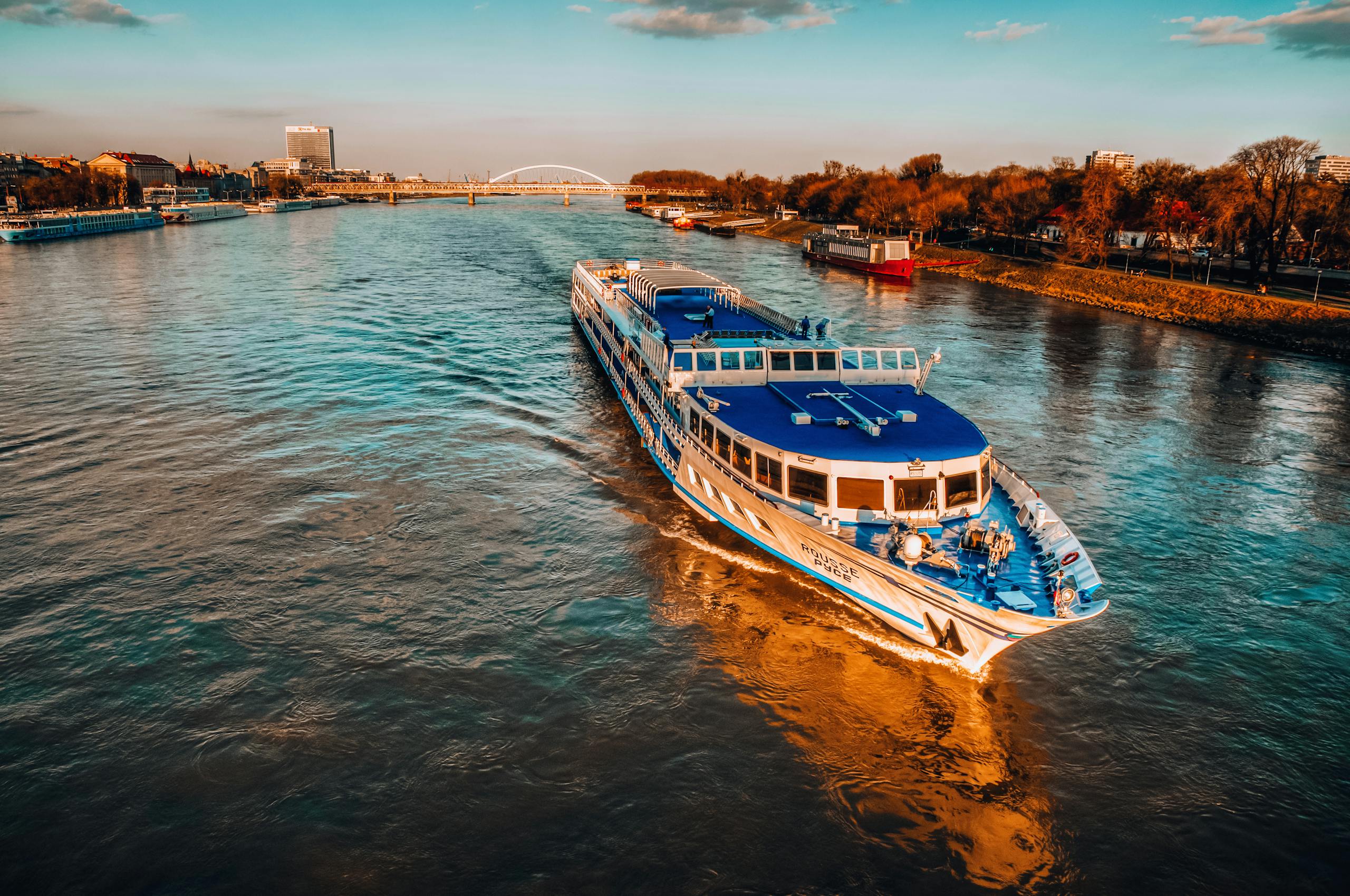 Capture of a cruise ship sailing on the Danube River during sunset in Bratislava, Slovakia.cruise travel advisor Simply Adventurous Travel