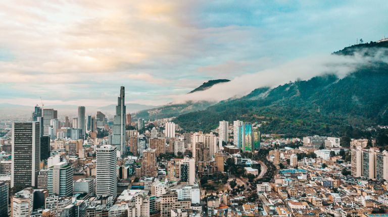 Aerial view of Medellín, Colombia surrounded by the green mountains of the Aburrá Valle